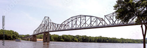 The Iowa DOT has temporarily closed the older iron truss, Black Hawk Bridge spanning the Mississippi River, joining Lansing IA, to Crawford County, WI. Wide panorama view from the North West in Iowa.