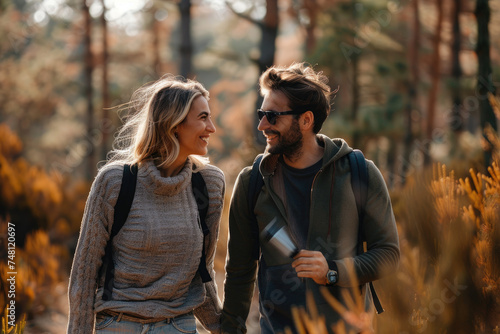 Happy couple talking while enjoying in walk in nature