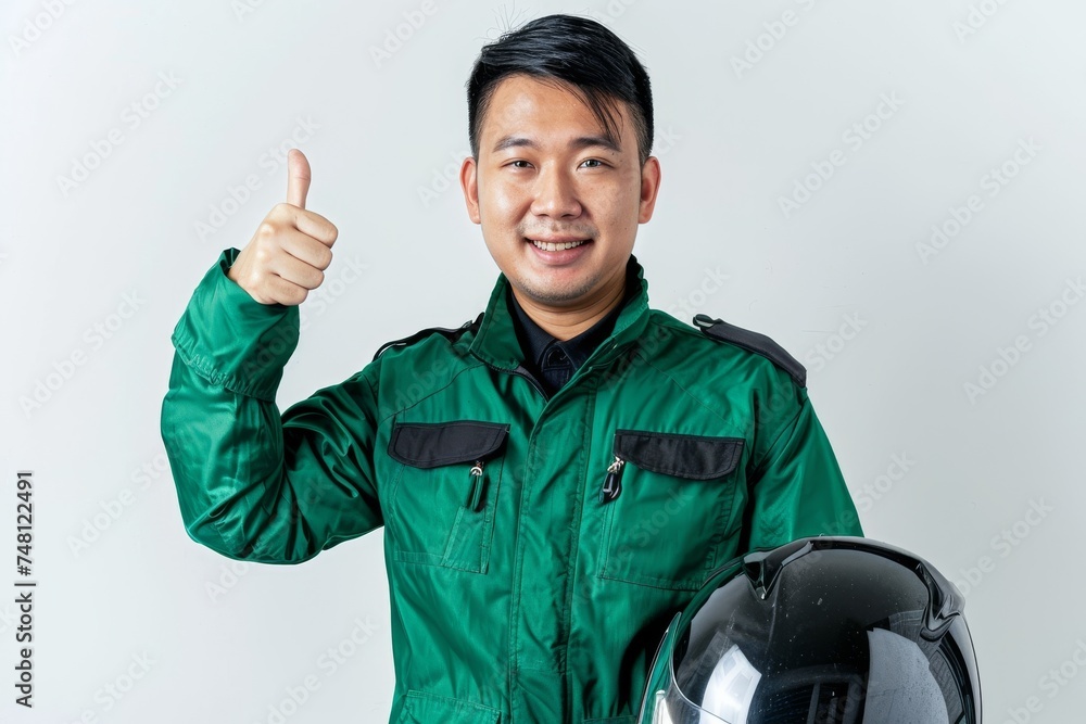Asian taxi driver in green jacket giving thumbs up holding helmet White background Asian taxi driver in green jacket giving thumbs up holding helmet White background