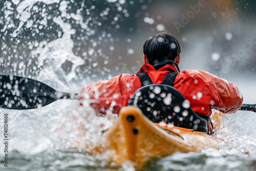 Focused Kayaker Conquering the Turbulent River © Angela
