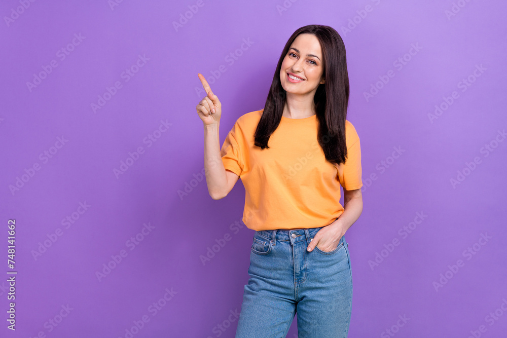 Portrait of pretty girl with stylish hairdo wear oversize t-shirt indicating at offer empty space isolated on violet color background Portrait of pretty girl with stylish hairdo wear oversize t-shirt indicating at offer empty space isolated on violet color background