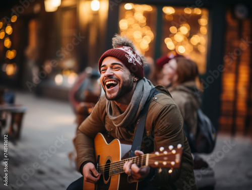 Young male busker singing and laughing while playing his acoustic guitar for passersby on a city sidewalk in winter