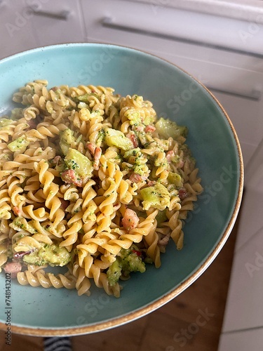 fusilli pasta, gimlet pasta with broccoli, pasta with pesto sauce and broccoli, small pieces of bacon, hot pasta on a plate