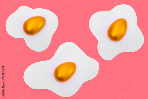 Creative layout made of scrambled eggs with decorated golden Easter eggs on a pink background. Minimal pink pattern background. Spring holidays concept.