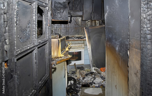 Kitchen with an old oven burned out after a fire in a house.