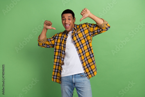 Portrait of excited positive person point thumb fingers self himself isolated on green color background