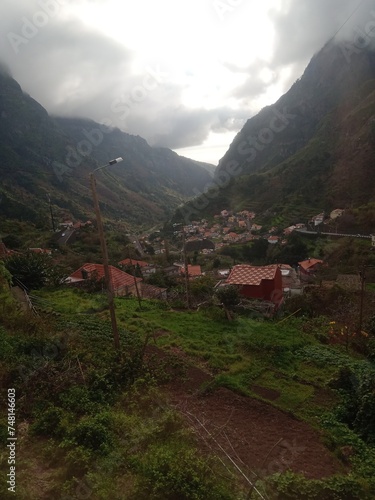 Little village between cloudy mountains