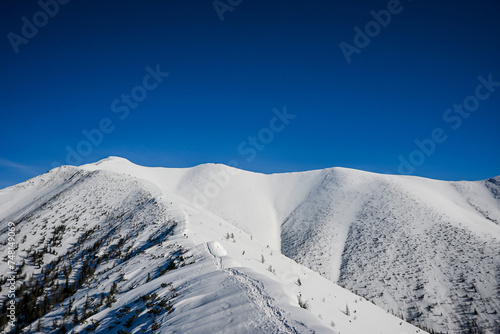 winter hiking to the top in the western Tatras Baranec, beautiful winter weather and lots of snow photo