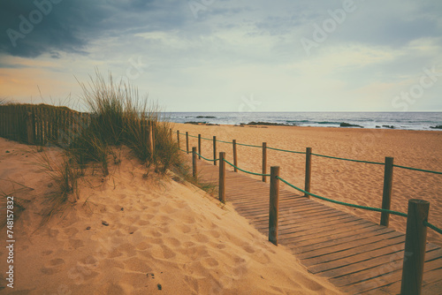 Wooden walkway on the sandy beach at sunset. Beautiful beach in the evening. Atlantic ocean. Porto  Portugal