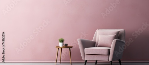 A single armchair and coffee table are placed against a pink wall in a rosy brown interior room. The room is devoid of people  offering a simplistic and modern aesthetic with a focus on minimalism.