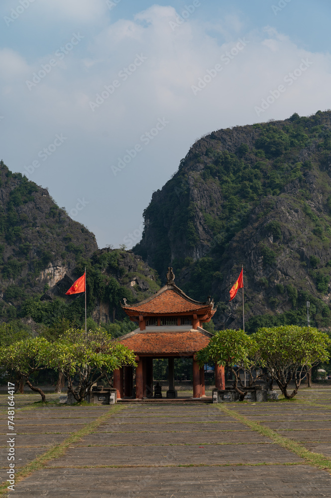 Blue skies and green vegitation surround the Temple of Empeor Le Dai Hahn in Ninh Binh region of Vietnam