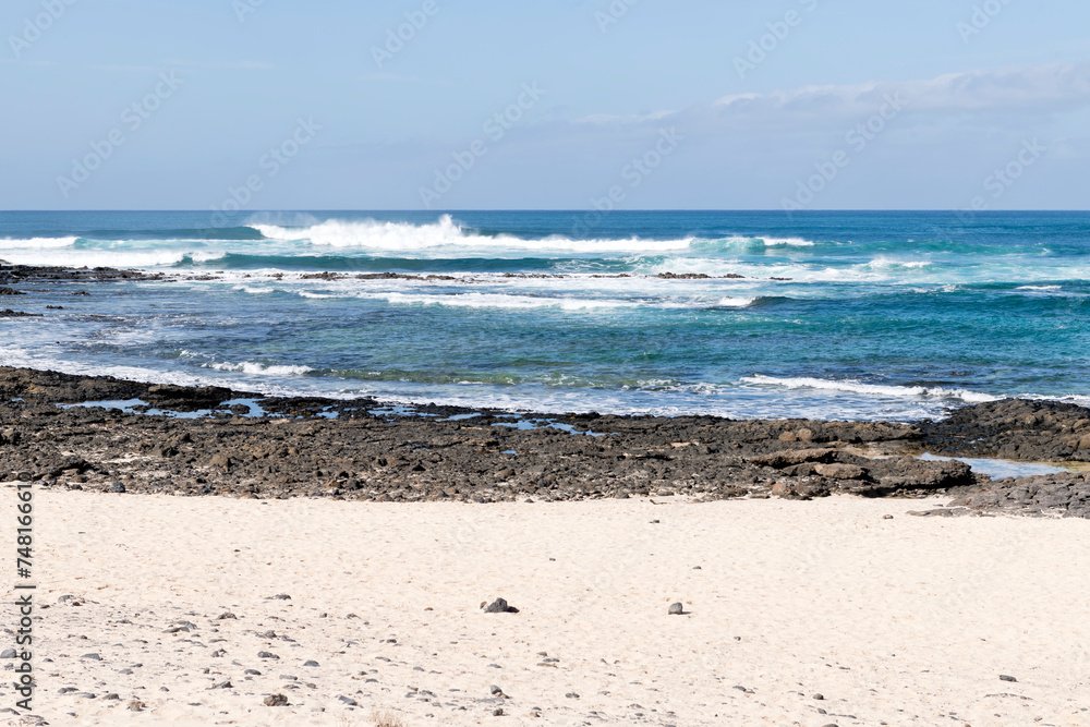 Waves crashing against the rocks at El Cotillo, Fuerteventura, Canary Islands Waves crashing against the rocks at El Cotillo, Fuerteventura, Canary Islands