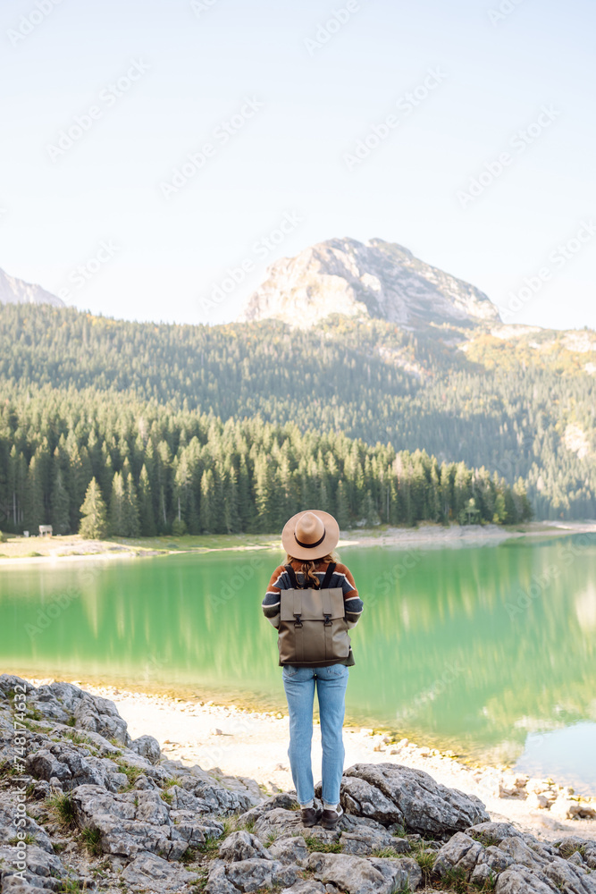 Active woman enjoys the beautiful scenery of the majestic mountains. Travel, adventure. Active woman enjoys the beautiful scenery of the majestic mountains. Travel, adventure.