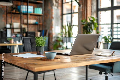 A modern home office with a wooden desk, laptop, and green plant. © Sandris