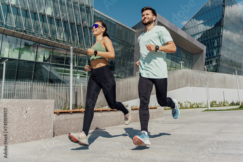 Fotografi Fit couple jogging together in an urban environment, promoting health and companionship