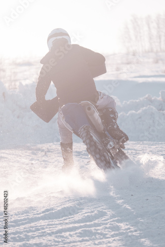 Extreme sport and enduro motorcycle concept. Motocross riders in action on the snow. Motocross winter extreme sport.