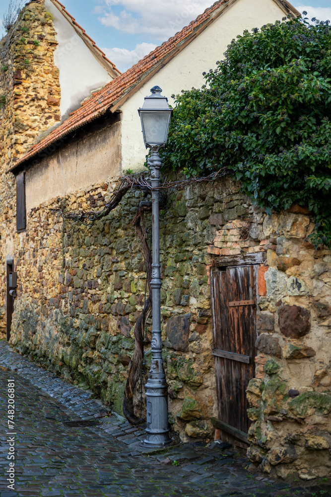 Fototapeta premium cast-iron, old street lamp on the old city wall
