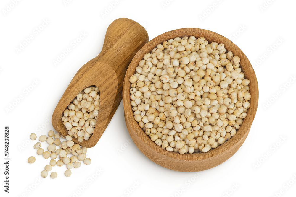 Sorghum seeds in wooden bowl and scoop isolated on white background. Top view. Flat lay. Sorghum seeds in wooden bowl and scoop isolated on white background. Top view. Flat lay.
