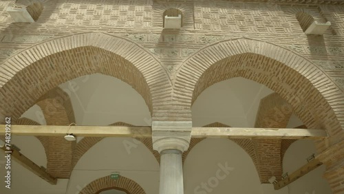 View from the brick arched porticoes of the Muradiye Madrasa building in Bursa. The camera moves horizontally. photo