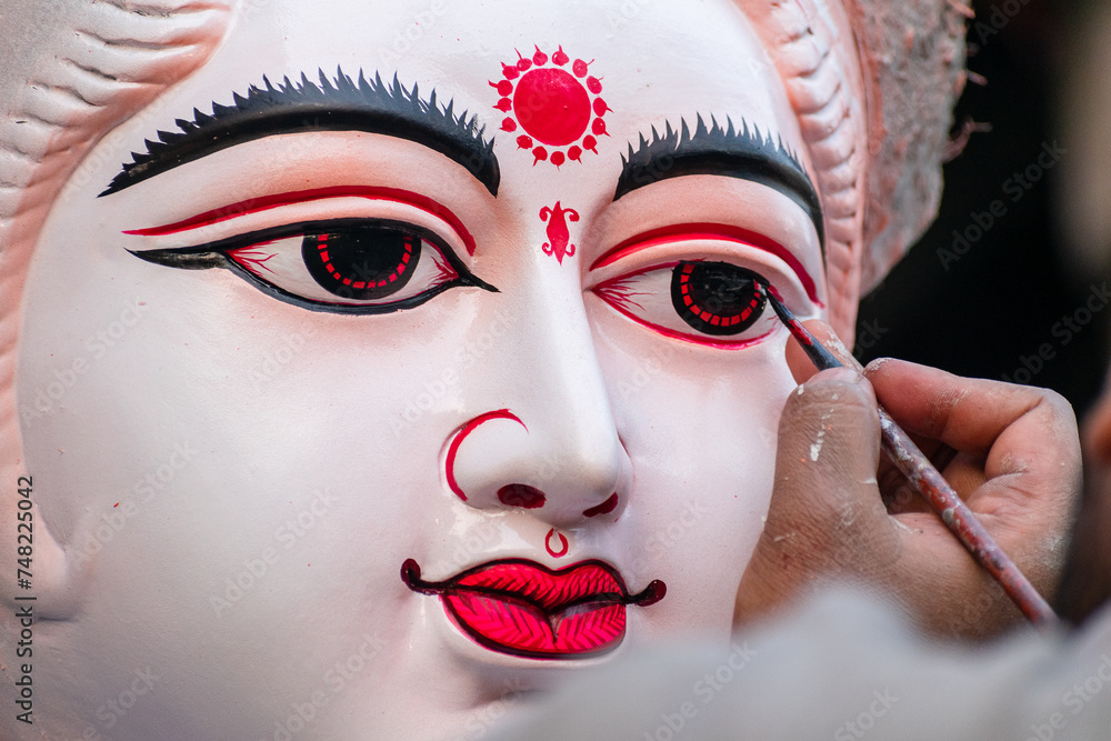 Painting the eyes of hindu goddess Saraswati idol from kumartuli Painting the eyes of hindu goddess Saraswati idol from kumartuli