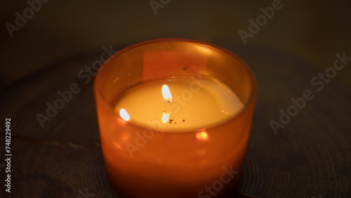 Close-up of flame of cozy candle. Media. Aromatic candle that creates cozy and spa atmosphere. Aroma candle with warm light and fragrance in spa