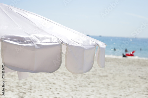 White beach umbrella on the beach 