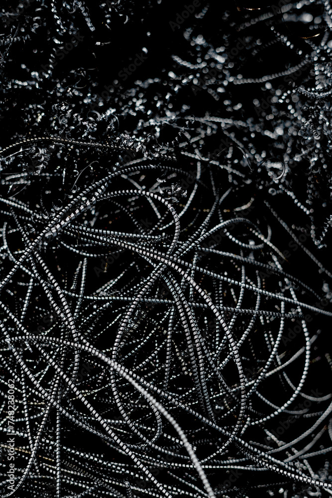 From above shot of bunch of black metal wires, modern industrial background