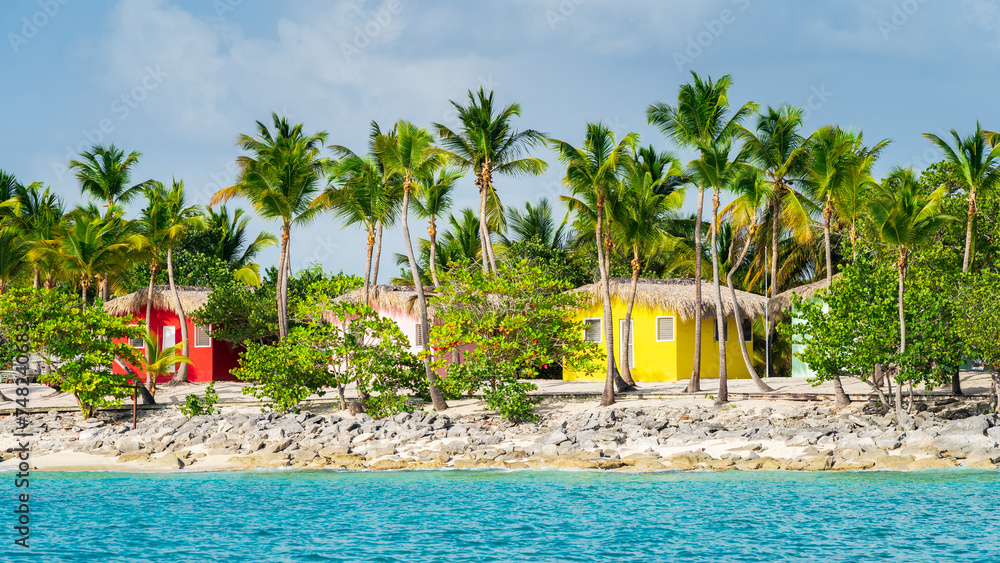 Colorful houses on Catalina beach, dominican republic with palm trees
