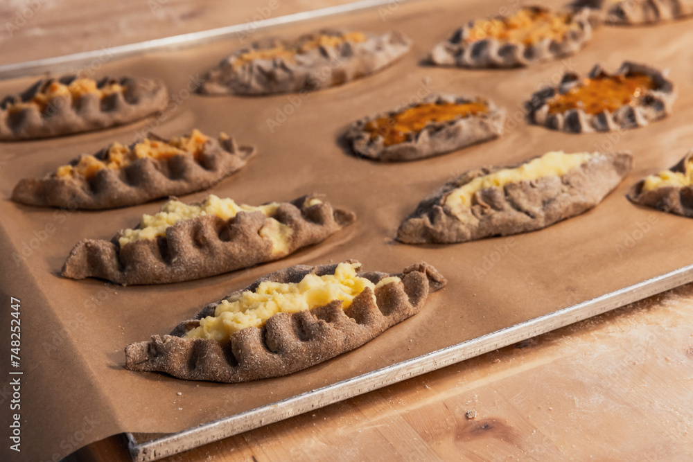 Karelian pasties with mashed potato and carrot filling - obrazy, fototapety, plakaty 