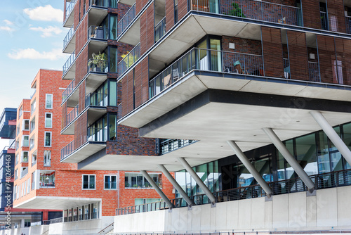 Konstfotografi Contemporary Residential Building brick facade houses on stilts metal pillars support beam Hamburg center downtown Germany