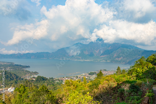 Panoramic view of a lake Batur (Danau Batur) surrounded by mountain, tropical landscape with colorful clouds in the sky. Danau Batur, Gunung Batur, Kintamani, Bali, Indonesia.