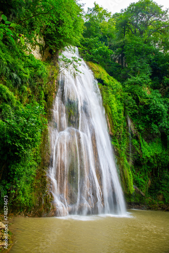 Lush Greenery Framing Lowe Waterfall  Loveh  Golestan Province  Iran