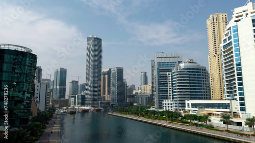 Panoramic view of high buildings with glass facade. Action. Real estate business in united arab emirates and water channel.