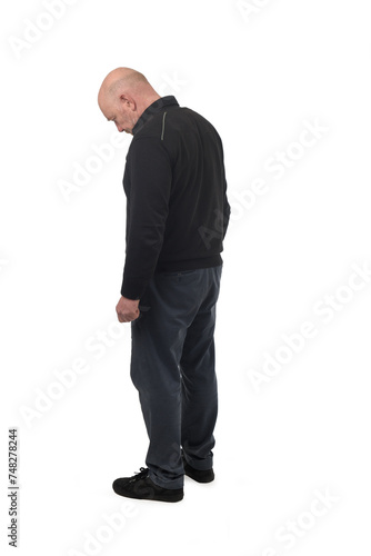 side view of a man looking down on white background