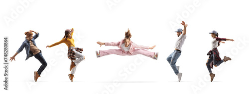 Girl making a split in the air between male and female dancers