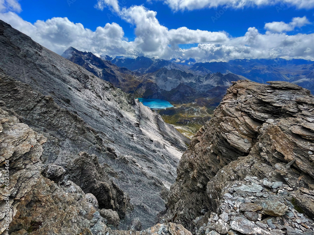 Discovering Peaks: High-Altitude Trail by Lake in Val d'Isere, aiguille de la grande sassière, France Discovering Peaks: High-Altitude Trail by Lake in Val d'Isere, aiguille de la grande sassière, France