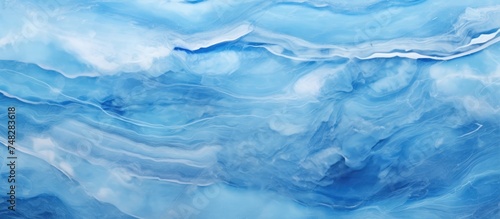 A painting featuring dynamic blue and white waves against a deep blue background. The waves appear to be in motion, creating a sense of movement and energy in the artwork.