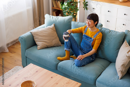 Woman relaxing at home drinking coffee