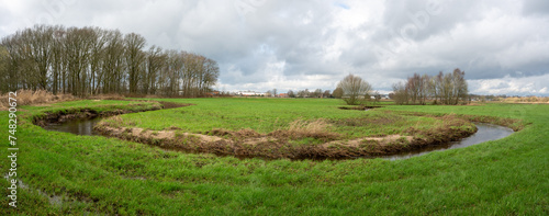 Rovertse Leij river winding through meadows outside of Goirle in The Netherlands
