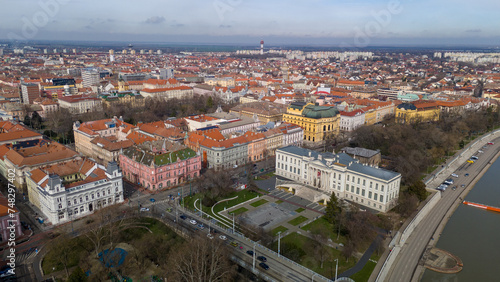 Drone footage from downtown of Szeged, Hungary on a sunny winter day. Szeged, Drone, Aerial, Hungary, Urban Landscape, Szeged Cathedral, Tisza River, Bridge