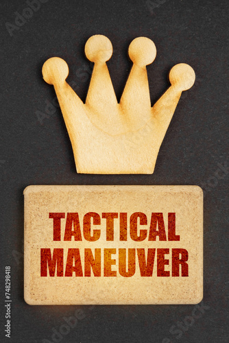 On a black background there is a wooden crown of the leader and a sign with the inscription - Tactical Maneuver