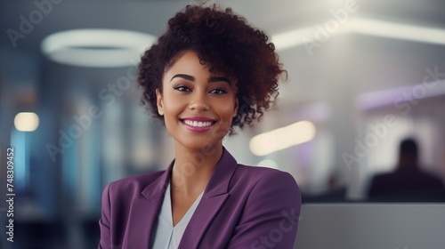 black business woman smiling in the office in a purple suit