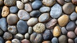 River rock pebbles, meticulously smoothed by nature's, Backdrop showcasing the inherent elegance, stone wall, Sea stones background
