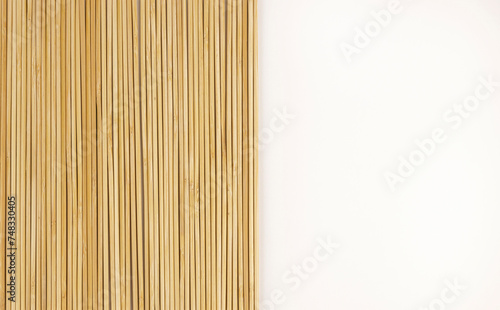 Bamboo sticks on a white background. Top view. Bamboo background for your product design.