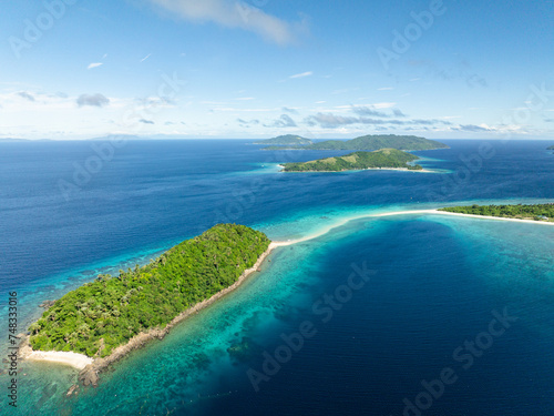 Islands with beaches surrounded by blue sea. Blue sky and clouds. Romblon, Romblon. Philippines.