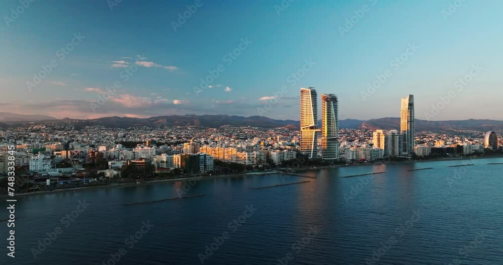 Sunset Over Limassol City, Republic of Cyprus at golden hour. Aerial Perspectives of Limassol's Modern Urban Landscape with High-Rise Glass Structures. Sunset Over Limassol City, Republic of Cyprus at golden hour. Aerial Perspectives of Limassol's Modern Urban Landscape with High-Rise Glass Structures.
