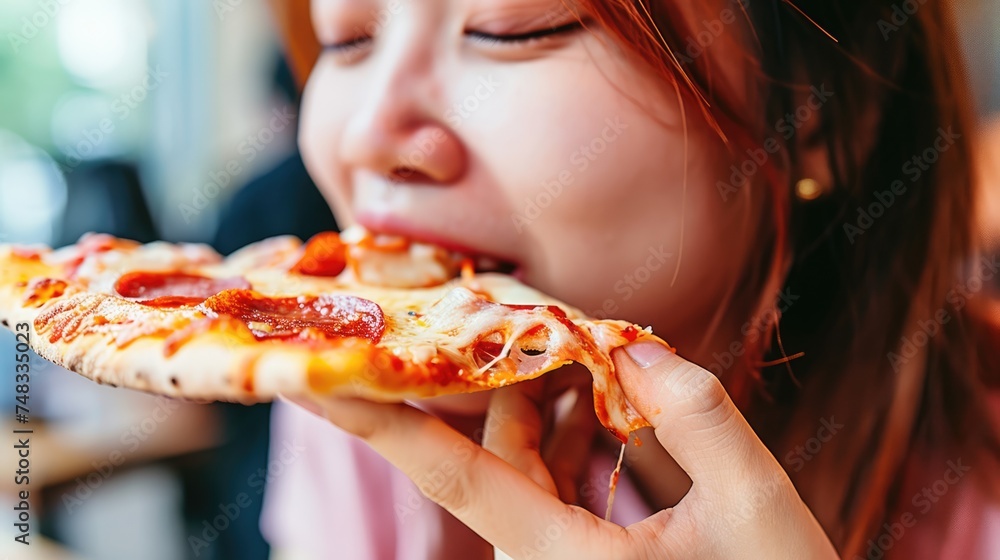 With great gusto, the girl eagerly indulges in her pizza, thoroughly enjoying the flavorful experience. With great gusto, the girl eagerly indulges in her pizza, thoroughly enjoying the flavorful experience.