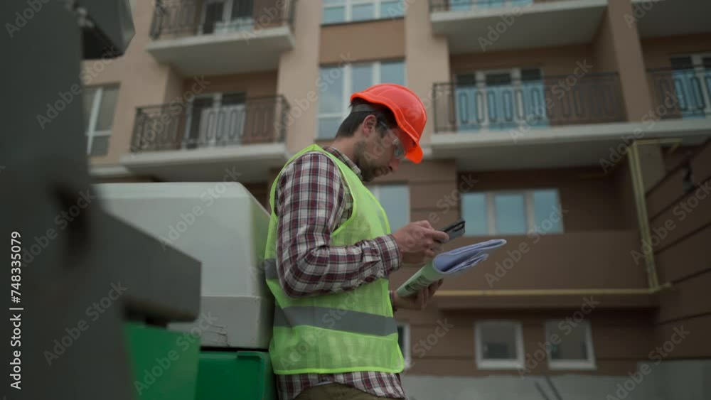 custom made wallpaper toronto digitalCivil engineer on construction site holding blueprints and smartphone in front of bulldozer for paving asphalt. Concept of apartment block constructions. Builder with roadmap near machinery.