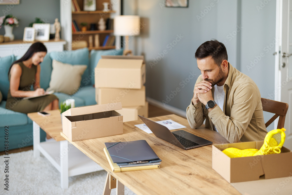 Man thriving in home office with dropshipping business Man thriving in home office with dropshipping business