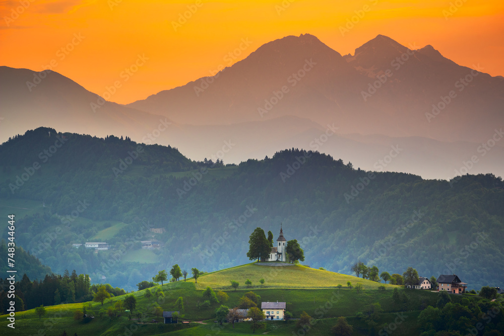 Sveti Tomaz, Slovenia. Church of Sveti Tomaz (Saint Thomas), Kamnik–Savinja Alps, beautiful colored sunrise sky.
